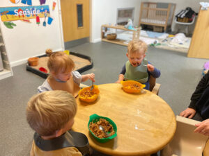 Children sat around a table eating