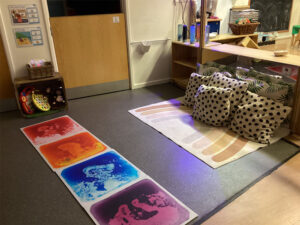 A mat with cushions in a nursery room